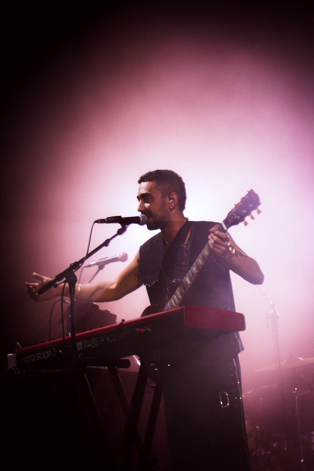 Darco Live — performing at the keyboard under pink stage haze