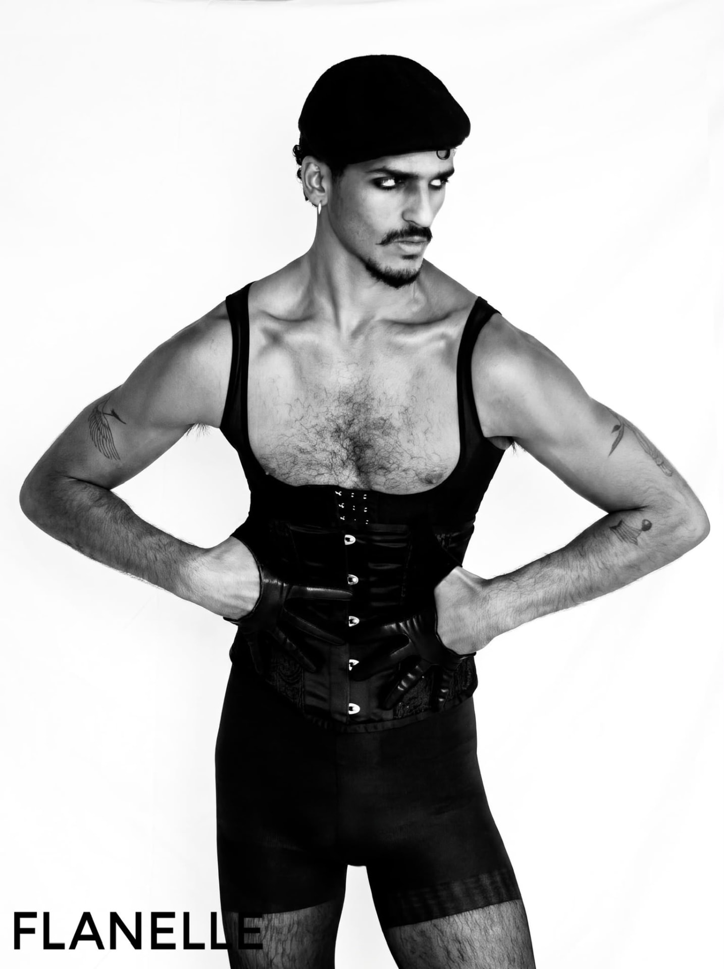 Figure in a leather corset and beret, hands on hips