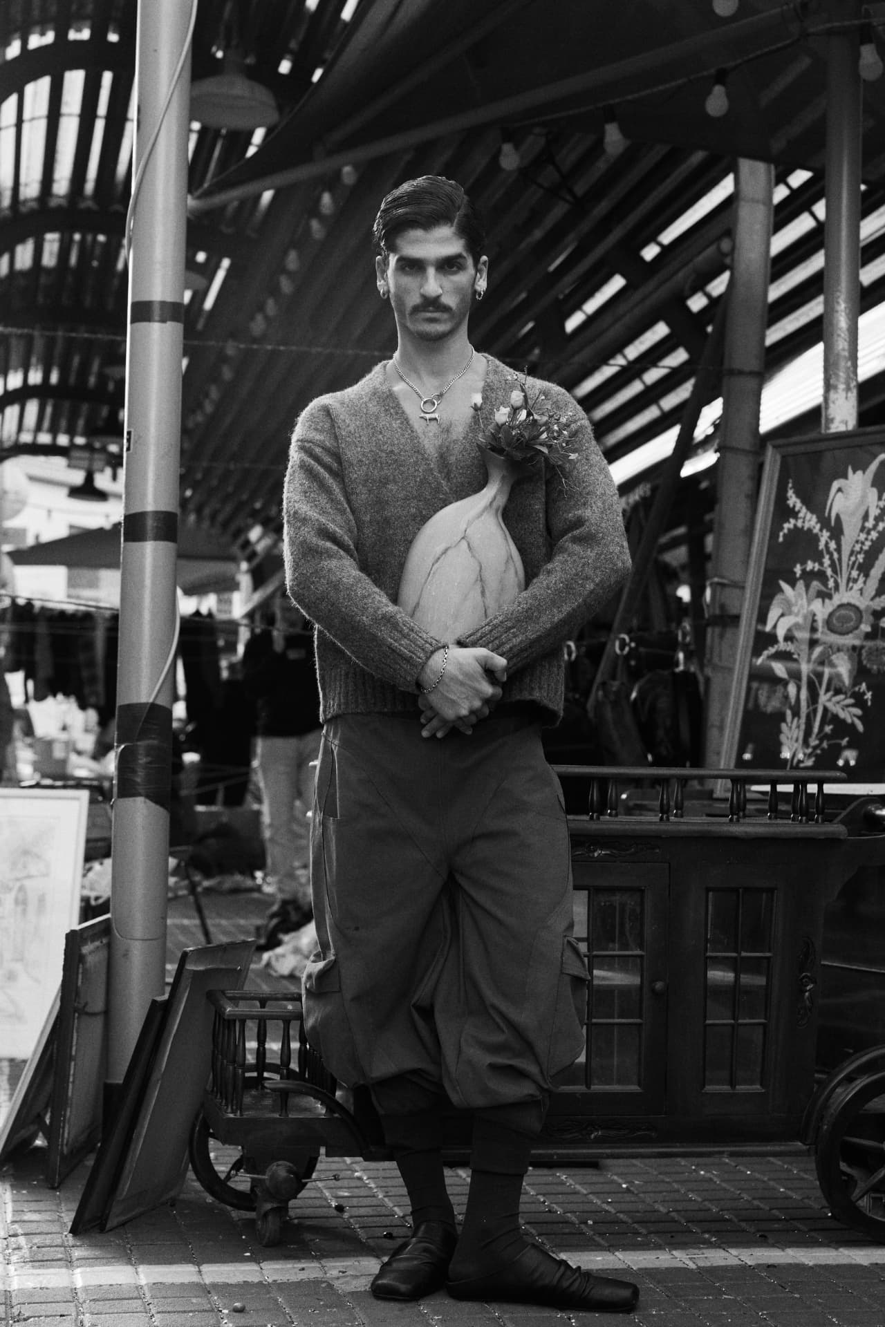 SELIN — model beneath a market canopy holding flowers