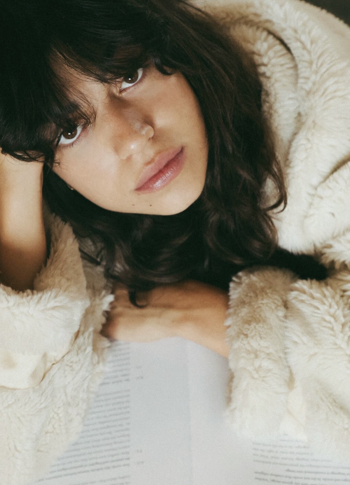 Portrait — dark hair against cream shearling