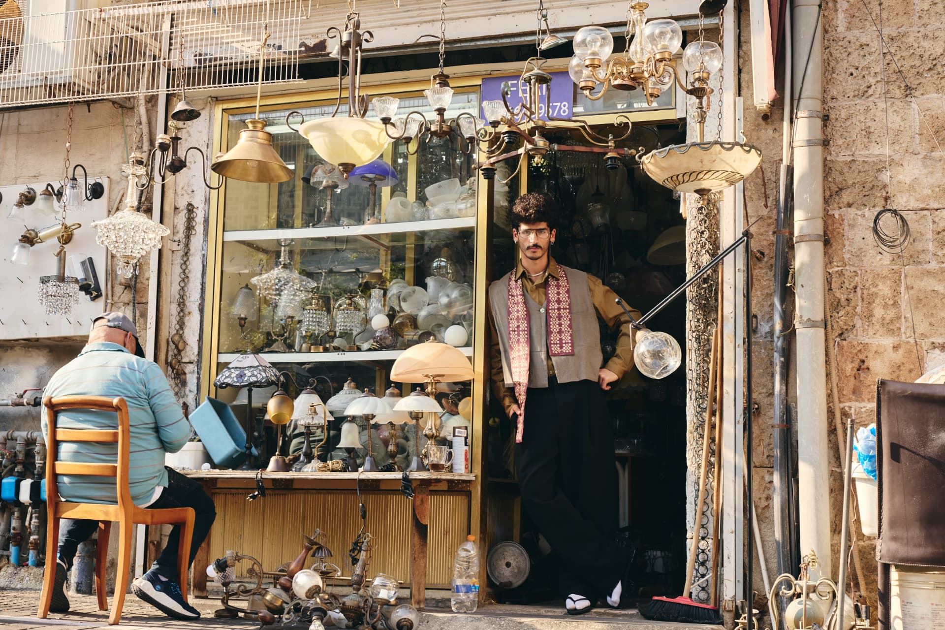 SELIN — wide view of a lighting shopfront with the model in the doorway