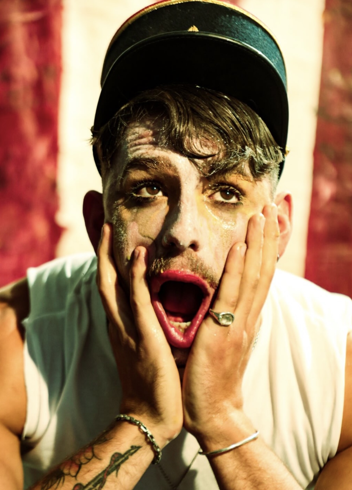 Character portrait — cap, painted face and open mouth